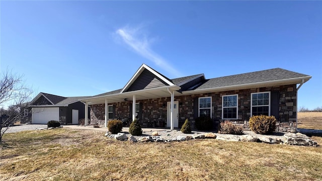 ranch-style home featuring covered porch, stone siding, a front lawn, and an attached garage