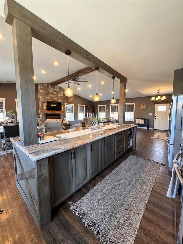 kitchen with open floor plan, plenty of natural light, and lofted ceiling with beams