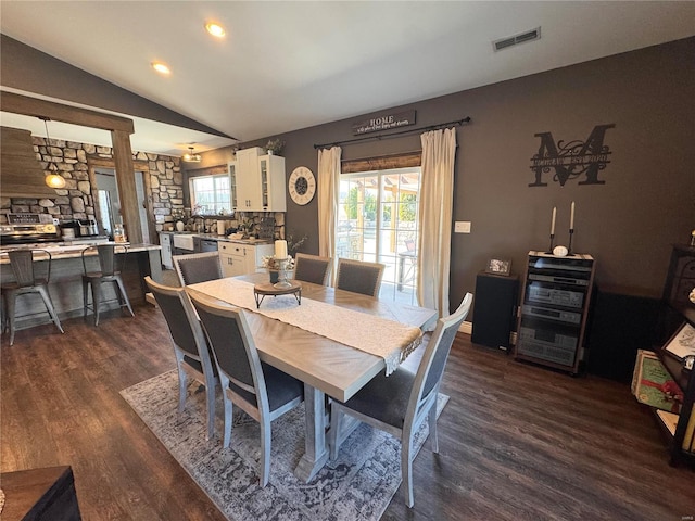 dining area with dark wood-style floors, recessed lighting, visible vents, and vaulted ceiling