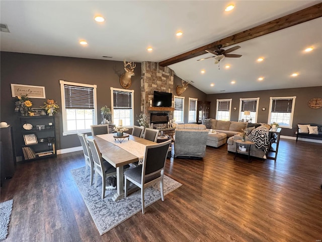 dining room featuring vaulted ceiling with beams, a fireplace, baseboards, and dark wood-type flooring