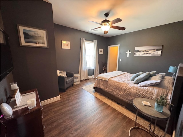 bedroom featuring ceiling fan, wood finished floors, and baseboards