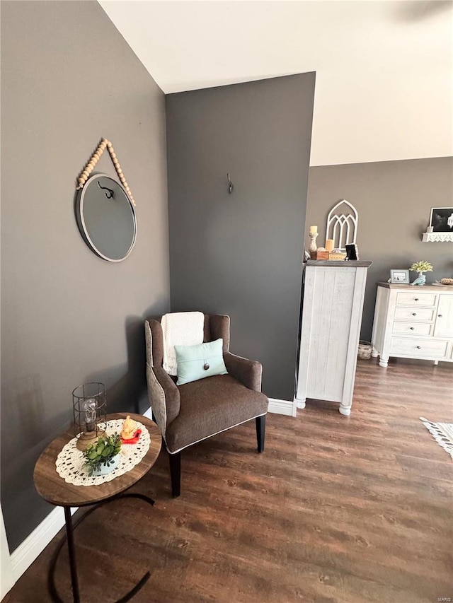 living area with wood finished floors and baseboards