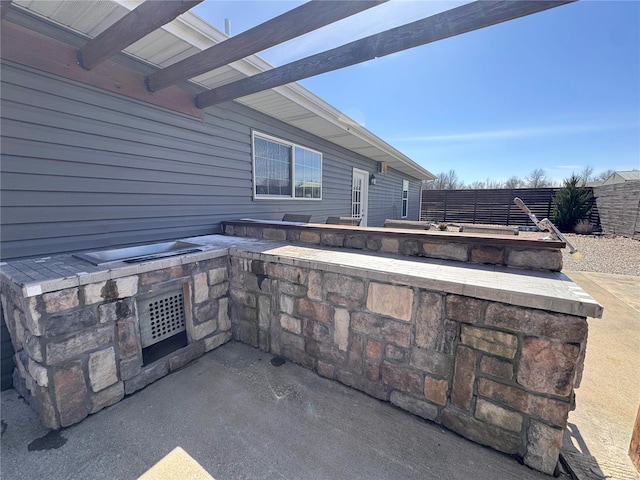 view of patio with area for grilling and a fenced backyard