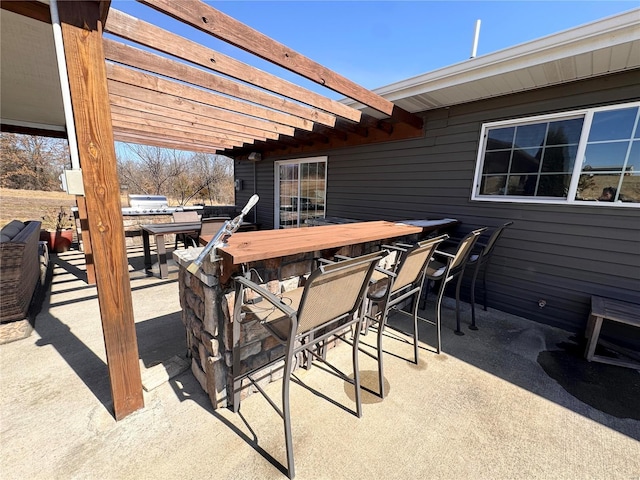 view of patio / terrace with outdoor dining space and a pergola