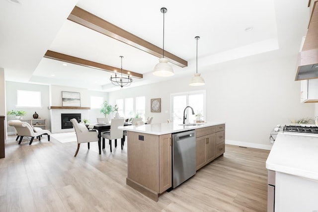 kitchen with extractor fan, light wood-style flooring, a sink, light countertops, and stainless steel dishwasher