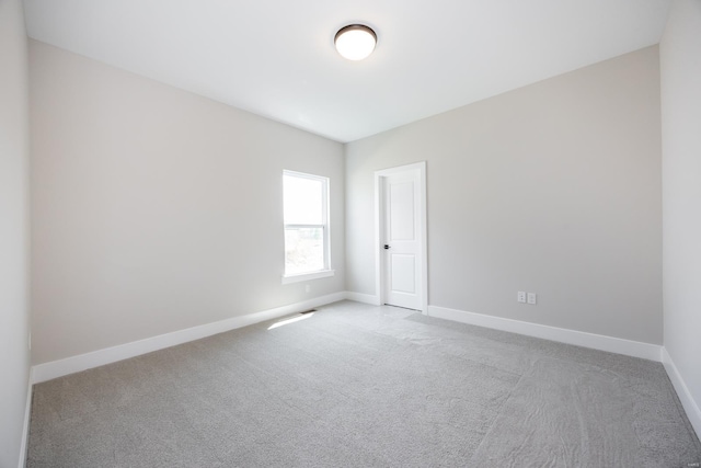 carpeted empty room with baseboards