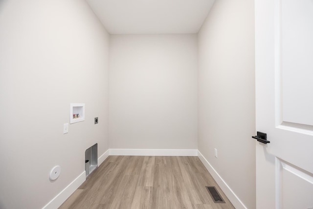 laundry room featuring hookup for a washing machine, laundry area, visible vents, baseboards, and light wood finished floors