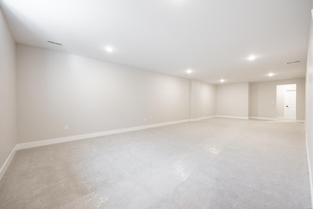 empty room with recessed lighting, visible vents, and baseboards