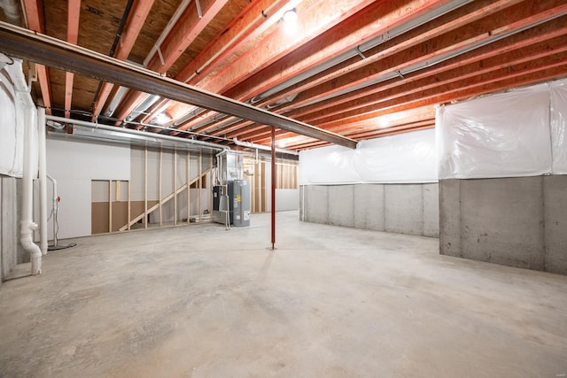 unfinished basement featuring water heater