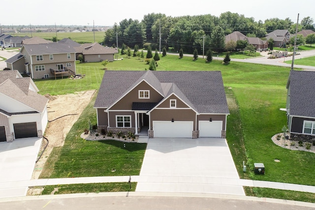 view of front of property featuring concrete driveway, a front lawn, roof with shingles, and a residential view