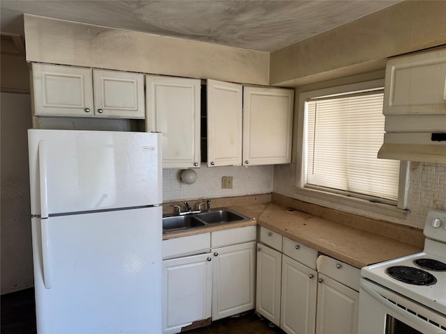 kitchen featuring white appliances, white cabinetry, a sink, and backsplash