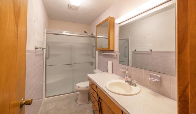 full bathroom featuring a stall shower, visible vents, tile walls, and toilet