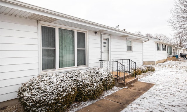 view of snow covered property entrance