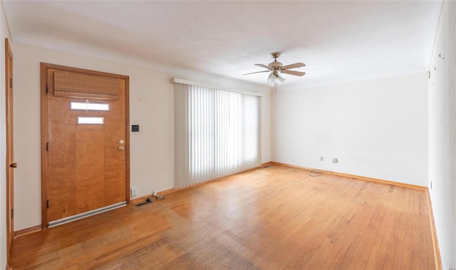 foyer featuring baseboards, a ceiling fan, and wood finished floors