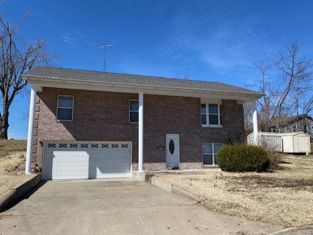 view of front of property with a garage, concrete driveway, and brick siding