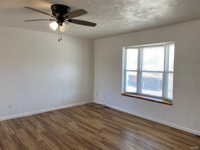 unfurnished room featuring wood finished floors and baseboards