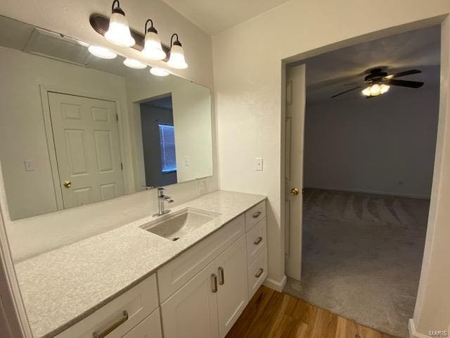 bathroom featuring ceiling fan, vanity, and wood finished floors