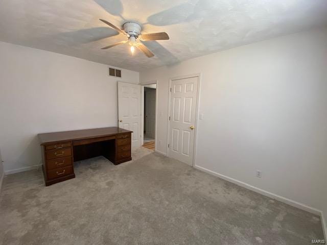 unfurnished office with baseboards, visible vents, ceiling fan, and carpet flooring