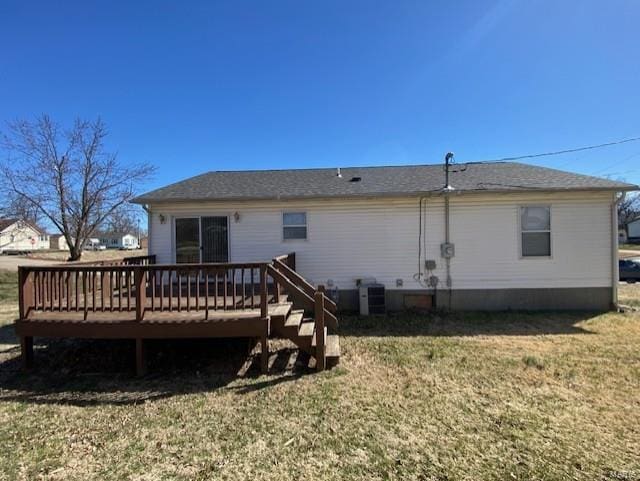 rear view of house with a wooden deck, central AC, and a yard