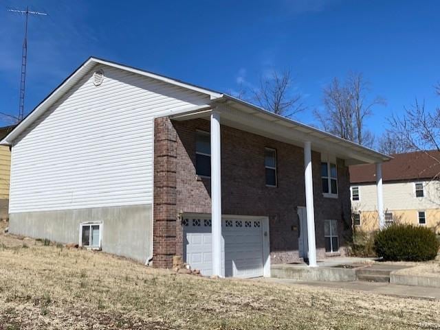 view of home's exterior featuring a garage and brick siding