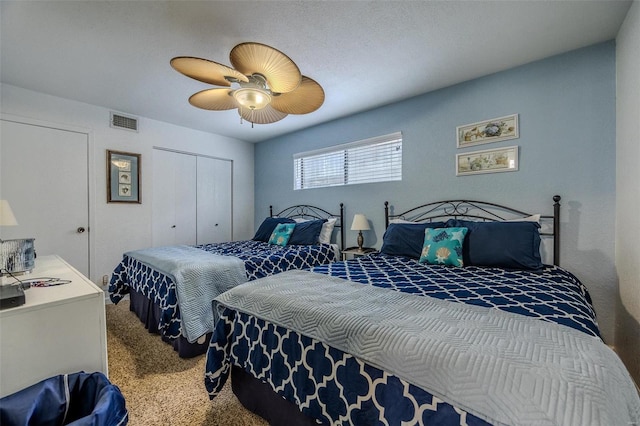 bedroom with carpet floors, a ceiling fan, visible vents, and a closet