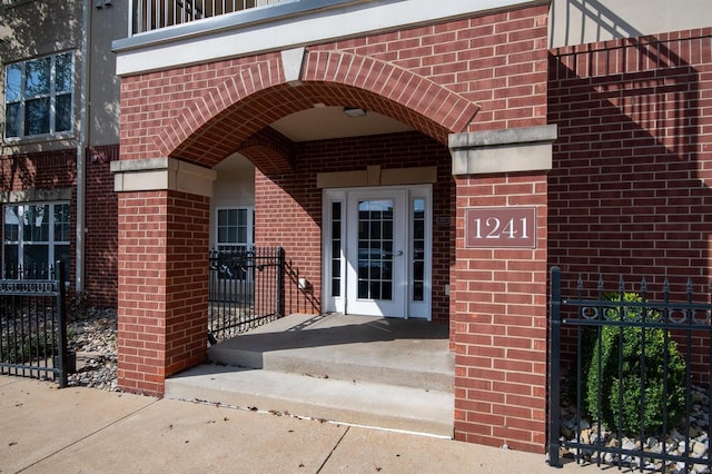 entrance to property featuring brick siding