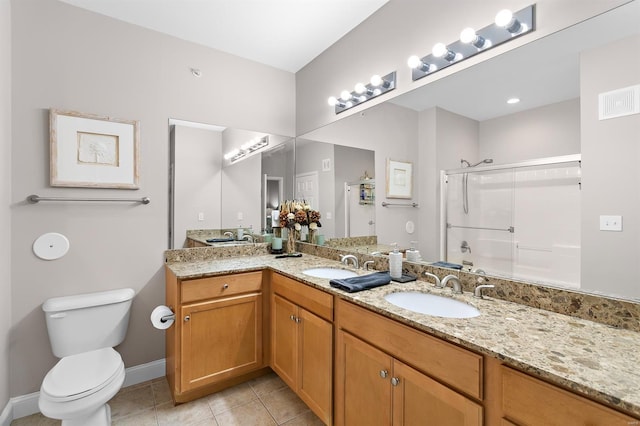 bathroom with toilet, a sink, visible vents, tile patterned floors, and a shower with door