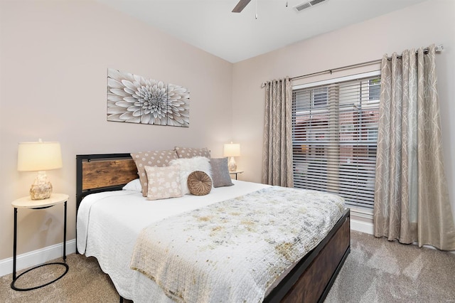 carpeted bedroom with ceiling fan and baseboards