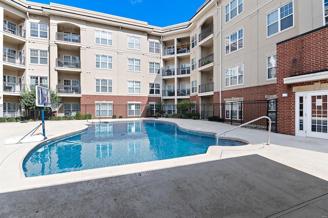 view of pool featuring fence