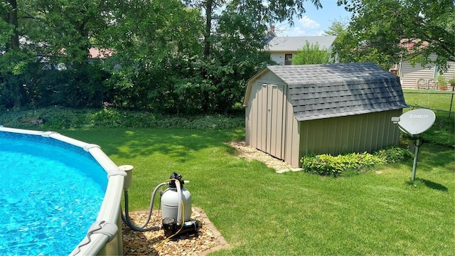 outdoor pool with a yard, a storage shed, and an outdoor structure