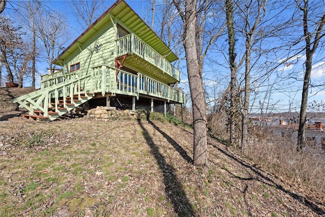 back of property with stairs and a deck