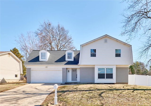 view of front of house featuring brick siding, driveway, an attached garage, and fence