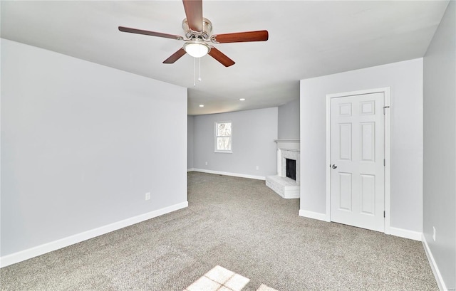 unfurnished living room featuring a fireplace, carpet flooring, and baseboards