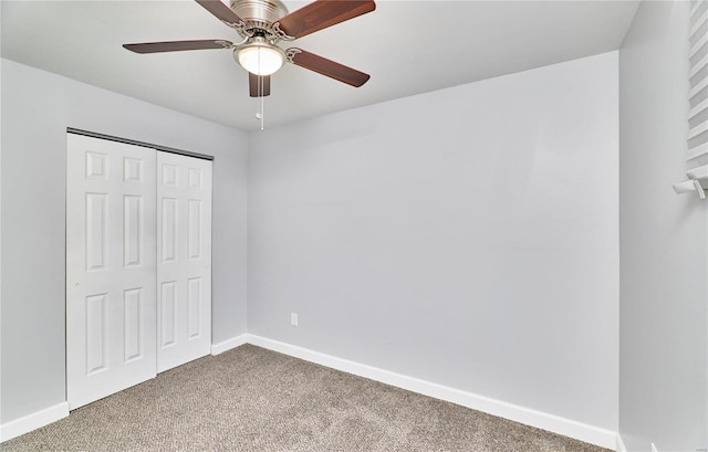 unfurnished bedroom featuring a ceiling fan, carpet, baseboards, and a closet