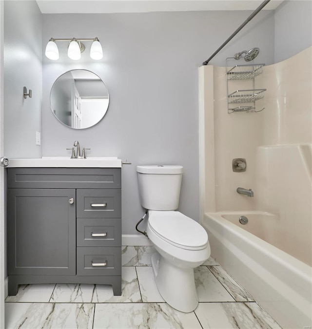 bathroom with bathtub / shower combination, toilet, vanity, baseboards, and marble finish floor