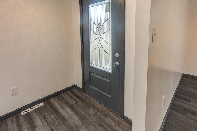 foyer entrance with dark wood finished floors, visible vents, and baseboards