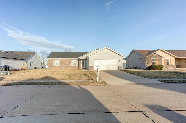 ranch-style home with driveway, an attached garage, a front lawn, and brick siding