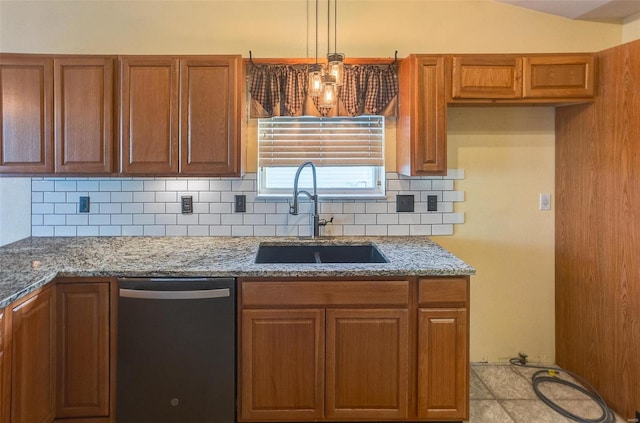 kitchen featuring dishwashing machine, tasteful backsplash, brown cabinets, and a sink