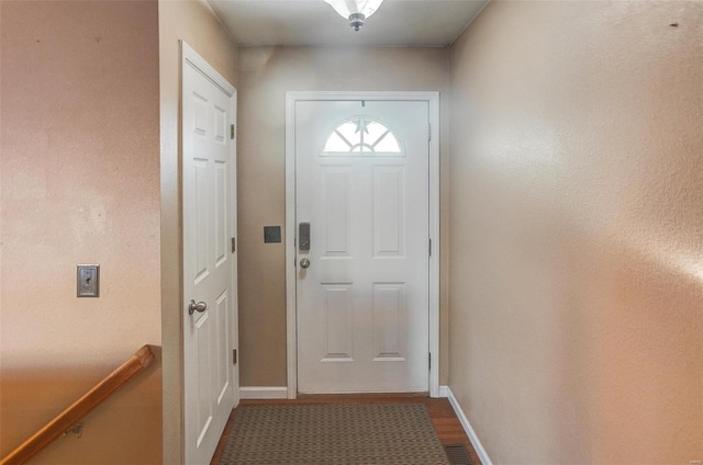 entryway featuring visible vents, baseboards, and wood finished floors