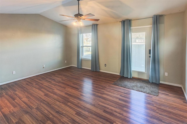 unfurnished room with lofted ceiling, ceiling fan, wood finished floors, and baseboards