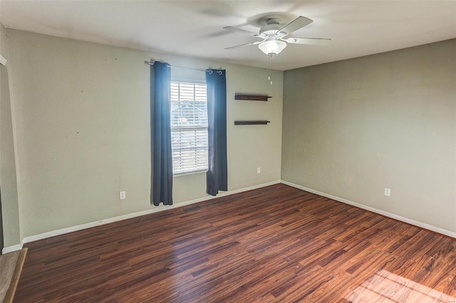 unfurnished room with wood finished floors, a ceiling fan, and baseboards