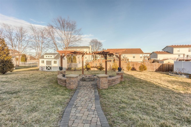 view of yard featuring an outbuilding, a fire pit, fence, a pergola, and a shed