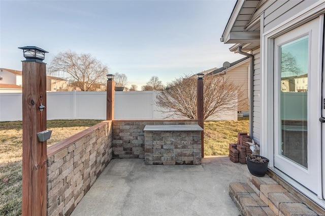 view of patio featuring fence