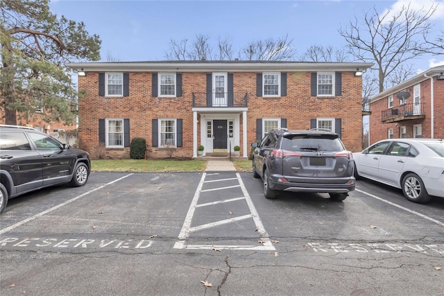 view of front of home featuring uncovered parking and brick siding