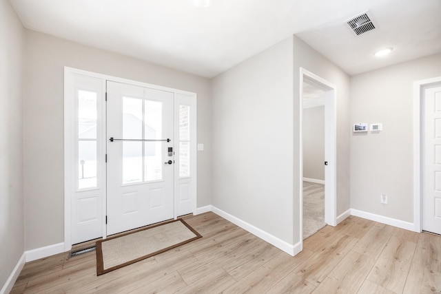 entrance foyer featuring visible vents, baseboards, and light wood-style flooring