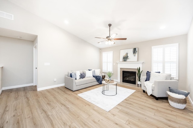 living area with ceiling fan, visible vents, baseboards, and wood finished floors