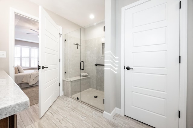 ensuite bathroom with recessed lighting, connected bathroom, a stall shower, and baseboards