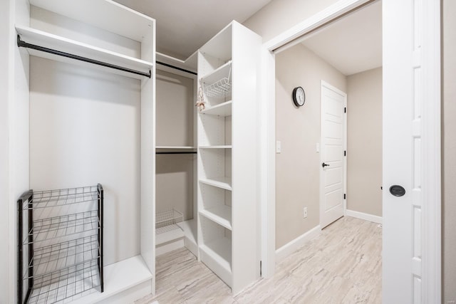 walk in closet featuring wood finished floors