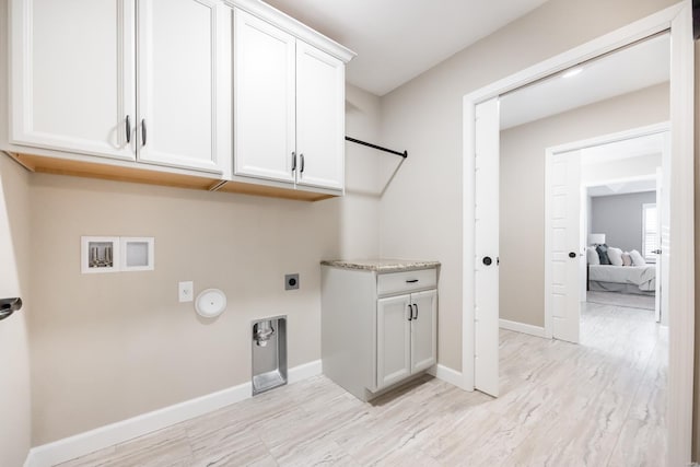 washroom with hookup for a washing machine, baseboards, hookup for an electric dryer, cabinet space, and hookup for a gas dryer