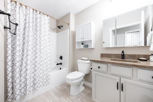 full bath with toilet, shower / bath combo with shower curtain, and vanity